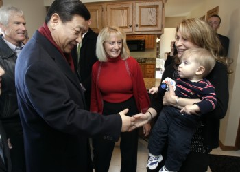 Chinese Vice President Xi Jinping greets Natalie Hansen Kimberley '00 and her eight-month-old son Austin. Looking on is her mother-in-law Martha Kimberley.