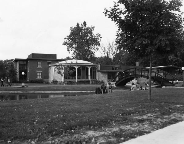 The original bridge was based on a Japanese wooden tea bridge and was much steeper and more slippery than today’s steel and concrete version. In the background, you can spot the first student union, in the same location as Maytag today.